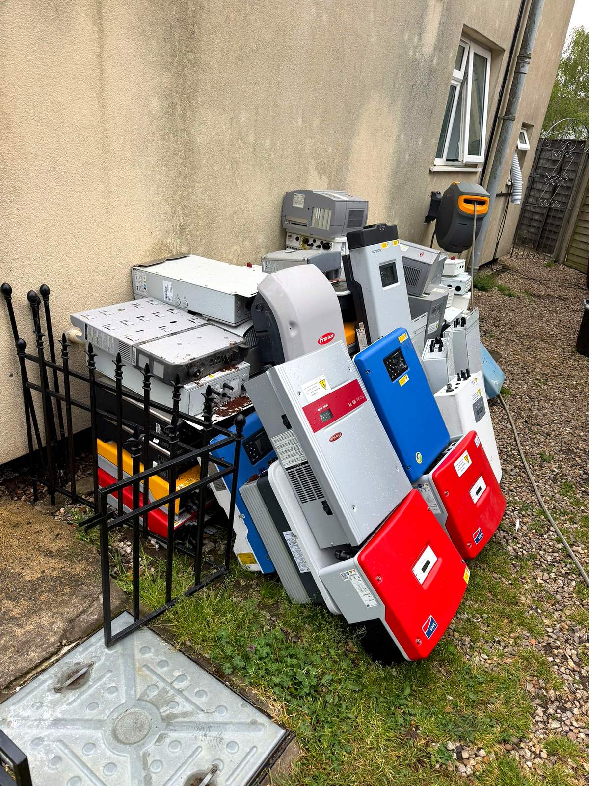 Fridges, washing machines and other white goods stacked ready for WEEE collection