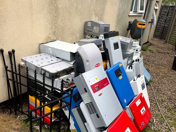 Fridges, washing machines and other white goods stacked ready for WEEE collection