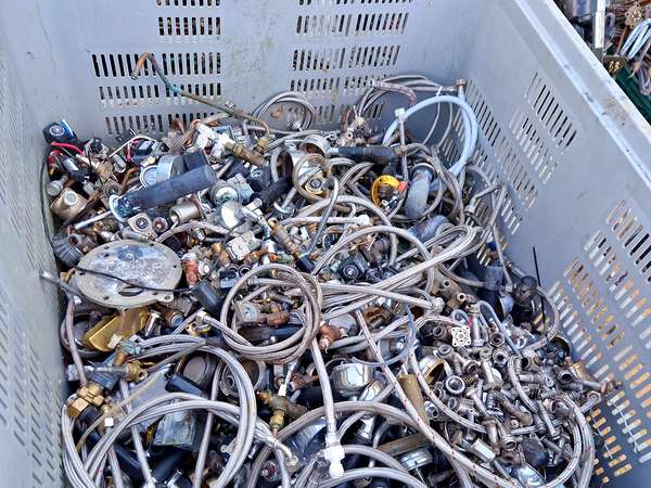 Crate of brass taps, valves and plumbing fittings sorted for scrap