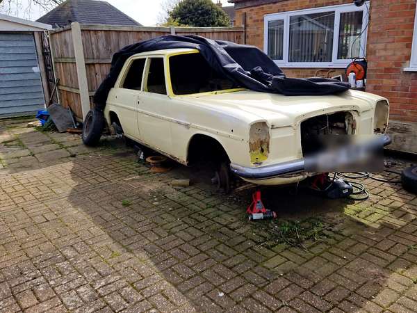 Unfinished project car cleared from a driveway