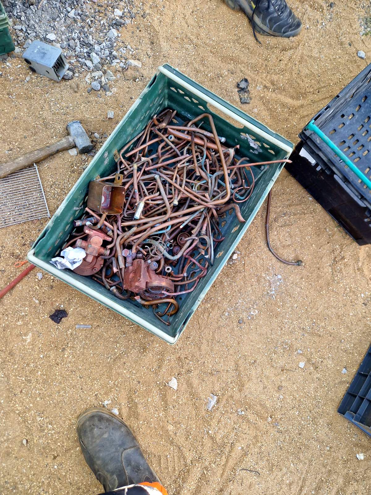 Crate of copper pipe and fittings collected from a plumbing strip out
