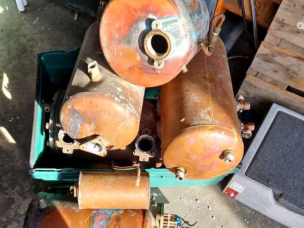 Copper cylinders stacked on a crate at the yard