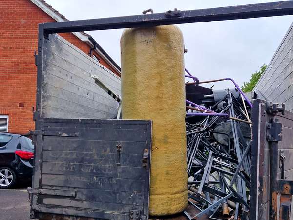 Tipper full of mixed scrap metal and a copper hot water cylinder